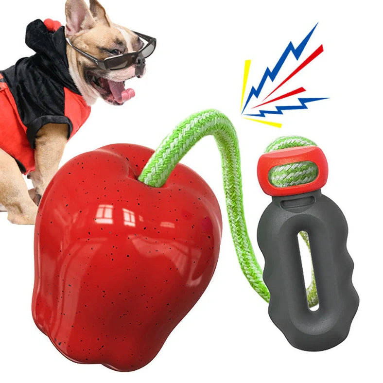 Green squeaky apple-shaped dog toy with treat-dispensing function, approximately 10-12cm diameter
