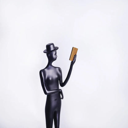 Black cast aluminium desktop sculpture of reading woman measuring 12x12x51cm with modern simplicity design