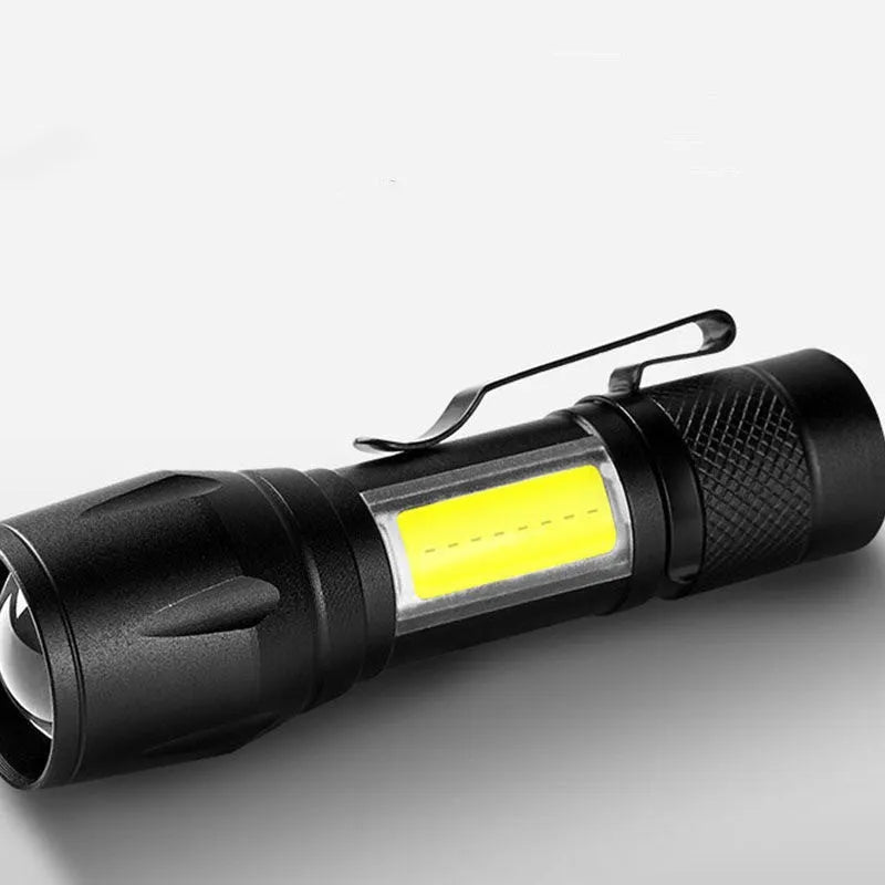 Black USB rechargeable LED flashlight with 10W output and aluminium alloy body, pocket-sized torch for hiking and camping.