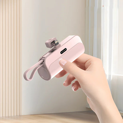 White capsule power bank showing compact 79mm size with USB charging ports visible