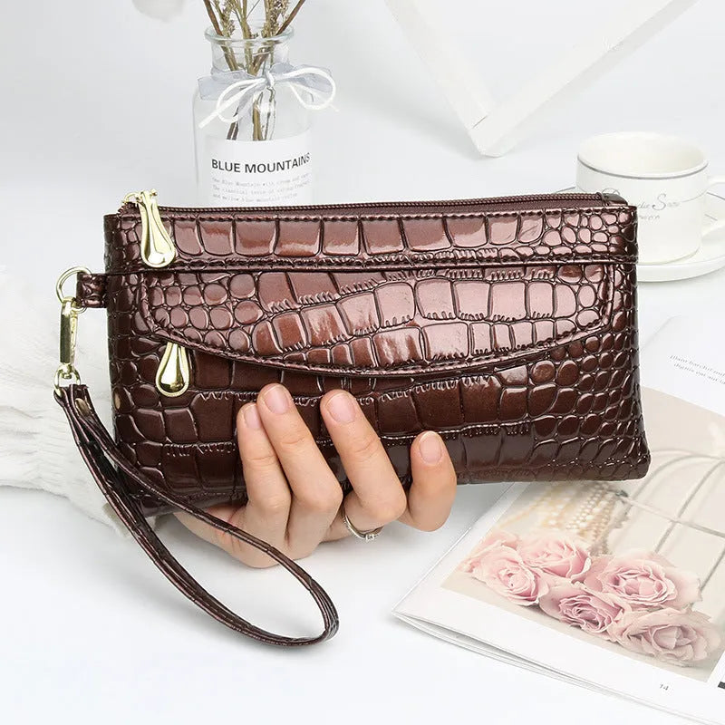 Women's black PU messenger bag showing horizontal square shape and shoulder strap