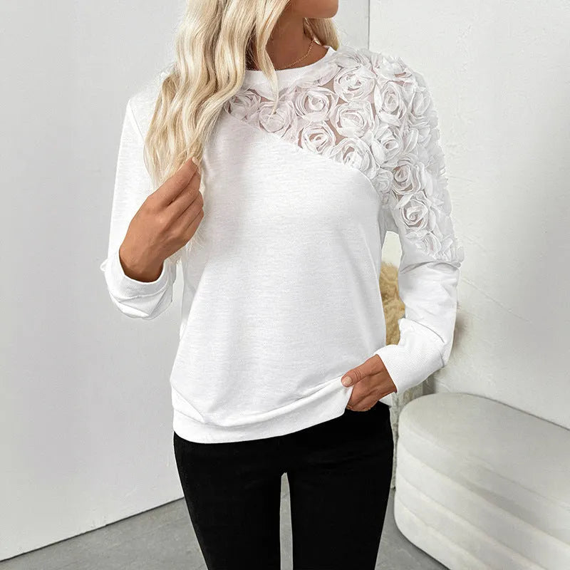 White long sleeve top with floral pattern, loose fit, regular sleeves, pullover style