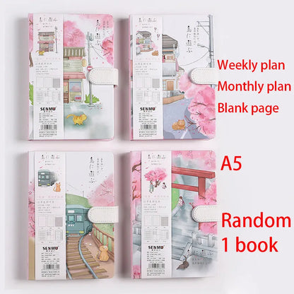 A5 wire-bound retro notebook open showing full-colour illustration of a train on its page