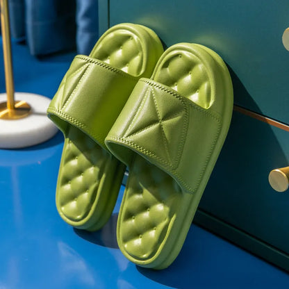 A pair of thick-soled EVA bathroom slippers in a selected colour, showing their injection-moulded non-slip design.