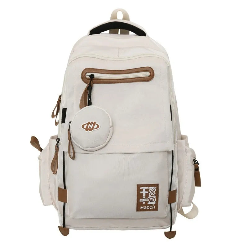 Large nylon school backpack for middle school students in a solid colour with curved shoulder straps.
