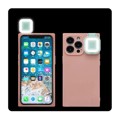Pink mobile phone case with built-in ring flash light for Apple iPhone 13 models on a white background.