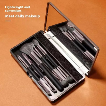 Makeup brush set with mirror compact case showing silver or gold brushes with artificial fibre bristles