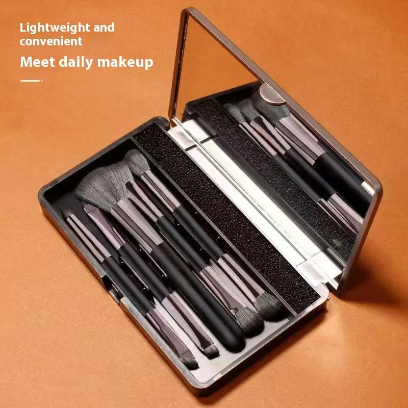 Makeup brush set with mirror compact case featuring artificial fibre brush heads and portable plastic handles in silver or gold finish with 2.6cm wool length for professional eyeshadow application