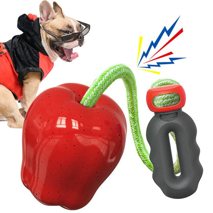 Green squeaky apple-shaped dog toy with treat-dispensing function, approximately 10-12cm diameter