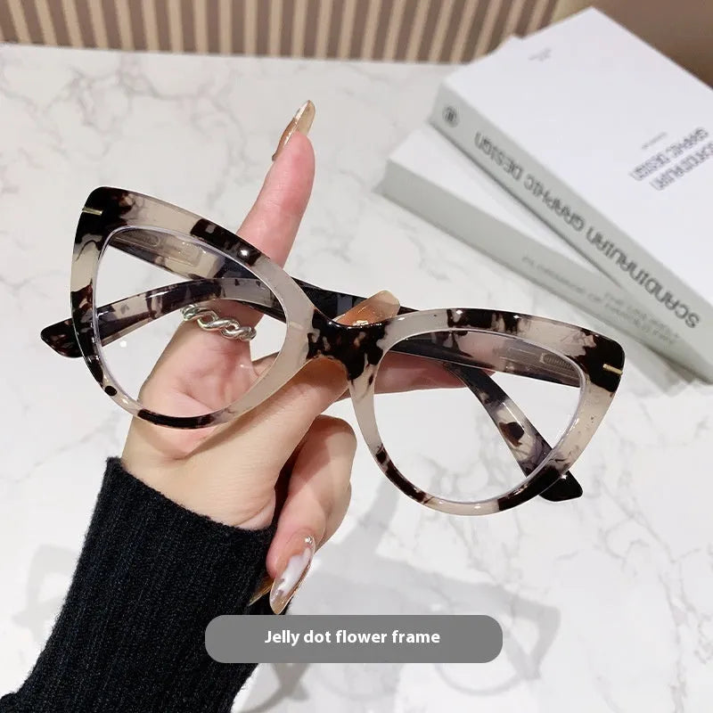Women's black cat's eye reading glasses with gold dragon and phoenix decorations on the temples.