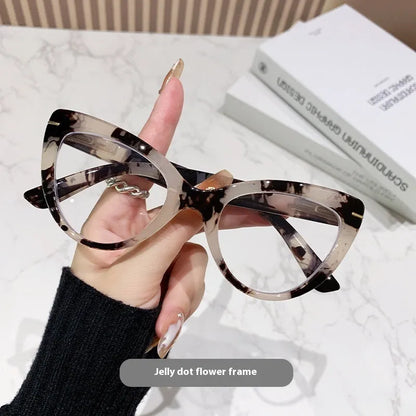 Women's black cat's eye reading glasses with gold dragon and phoenix decorations on the temples.