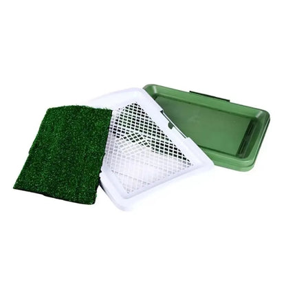 Green synthetic grass indoor dog toilet tray with plastic base for puppy training.