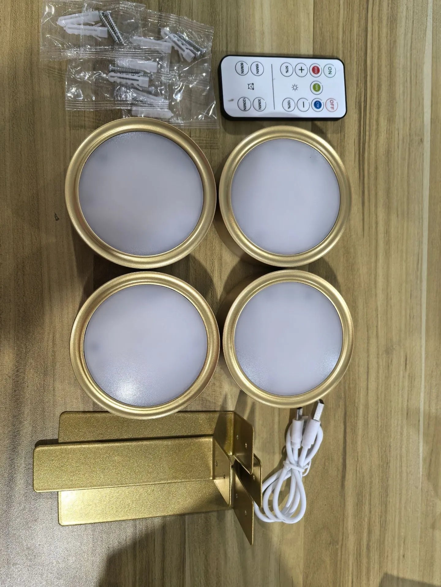 Black magnetic LED painting lamp with remote control on a white wall.