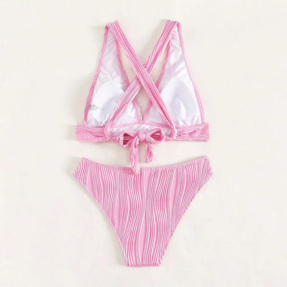 Pink women's halter neck bikini top and matching split-style shorts on a mannequin.