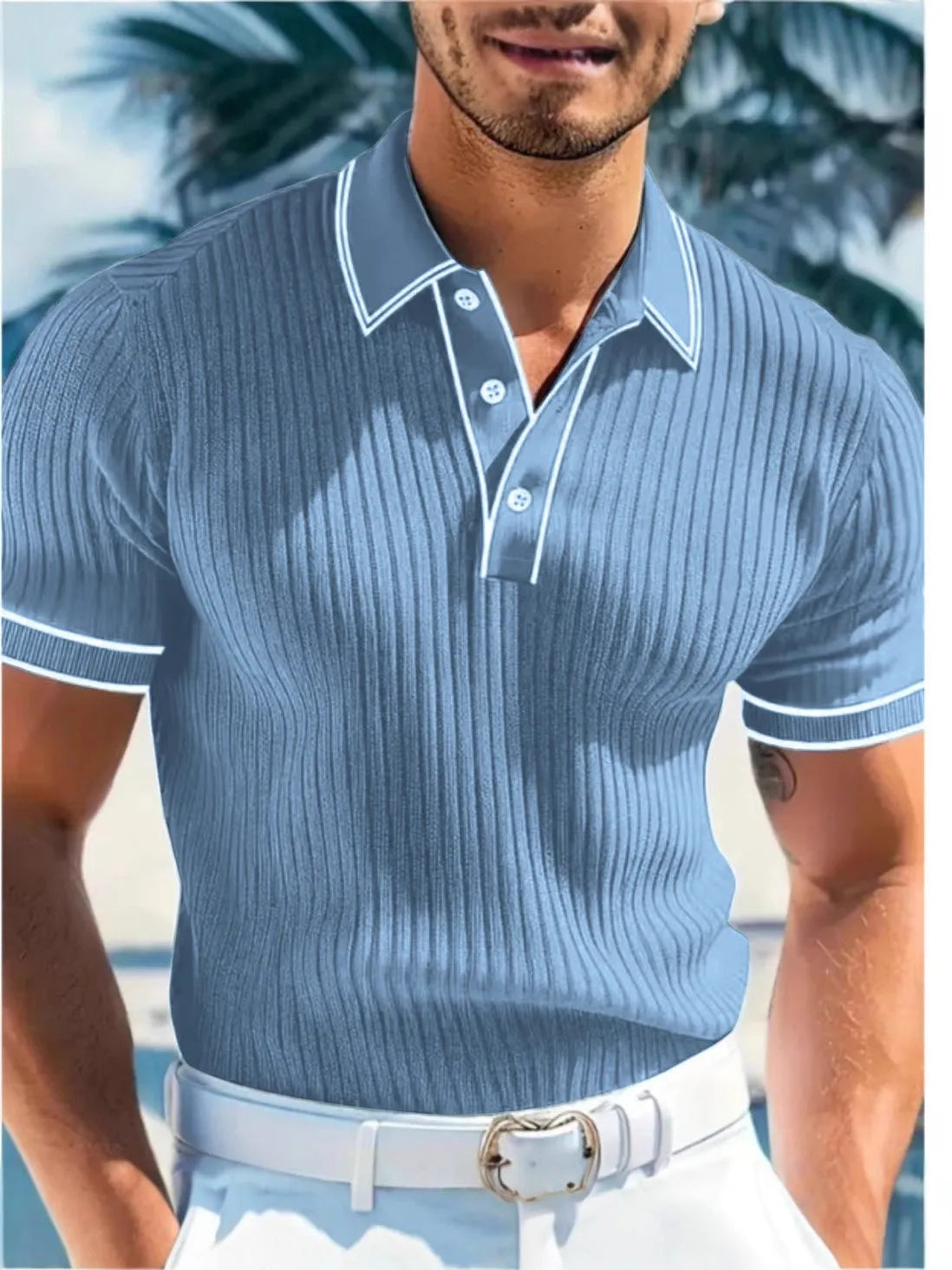 A man wearing a loose-fit, striped, short-sleeved polo shirt in a dark colour.