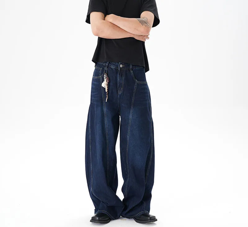 Woman wearing dark blue distressed wide leg denim jeans in a casual setting.