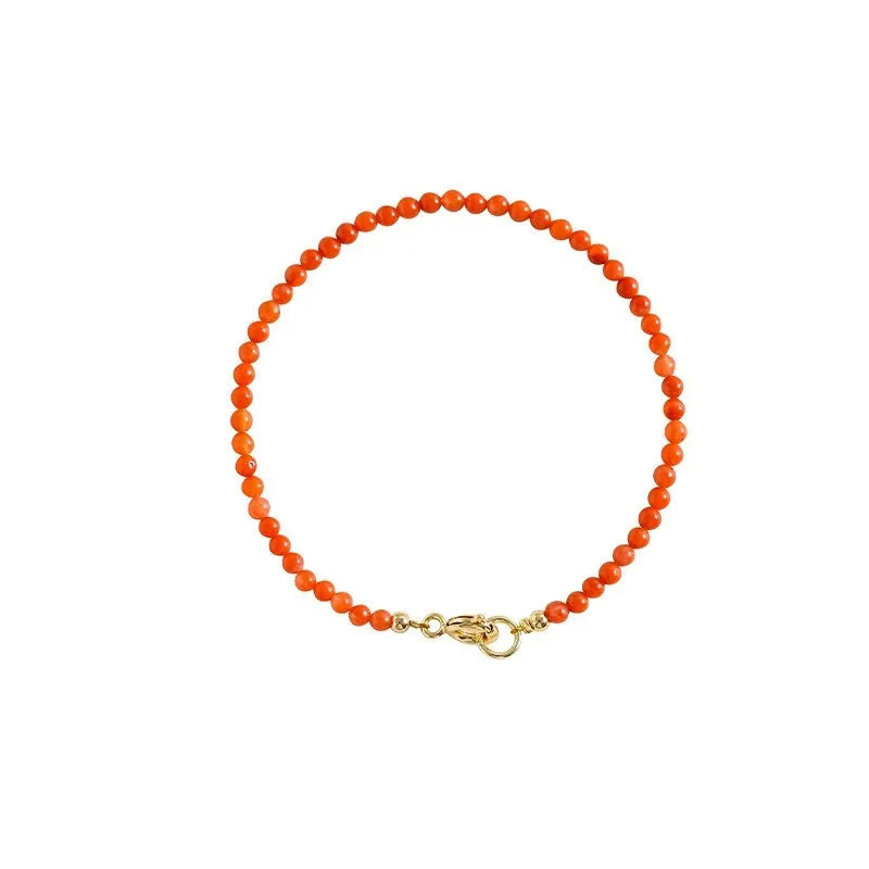 Close-up of a women's retro bracelet with a Southern Red Agate stone in cherry red on a wrist.