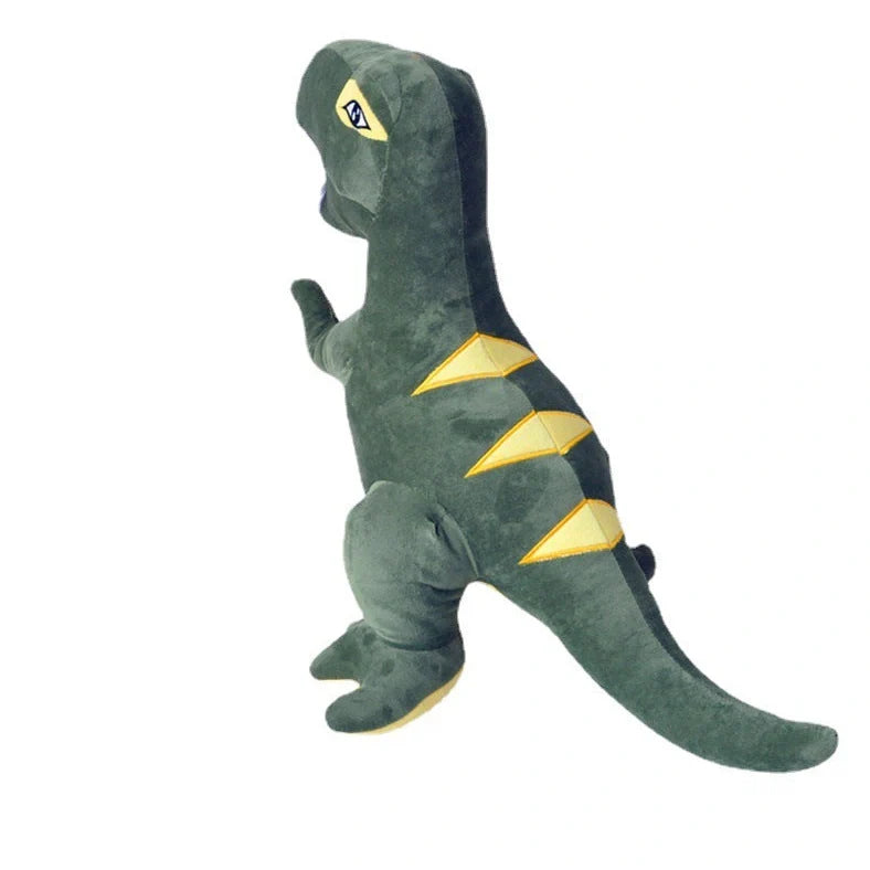 Green dinosaur plush toy with reversible sequins showing flipped design patterns