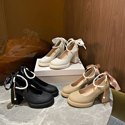 Women's beige Mary Jane shoes with chunky heel, ankle strap, pearl buckle, and round toe on a rubber sole.