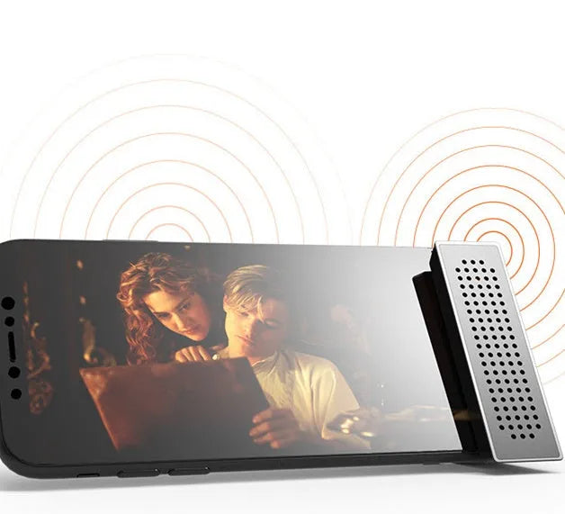 Portable black ABS plastic phone amplifier bracket holding a smartphone on a desk.
