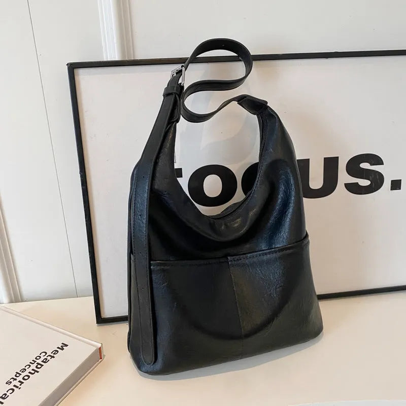 Women's soft PVC bucket shoulder bag with single strap, open pocket, phone pocket, and matching wallet