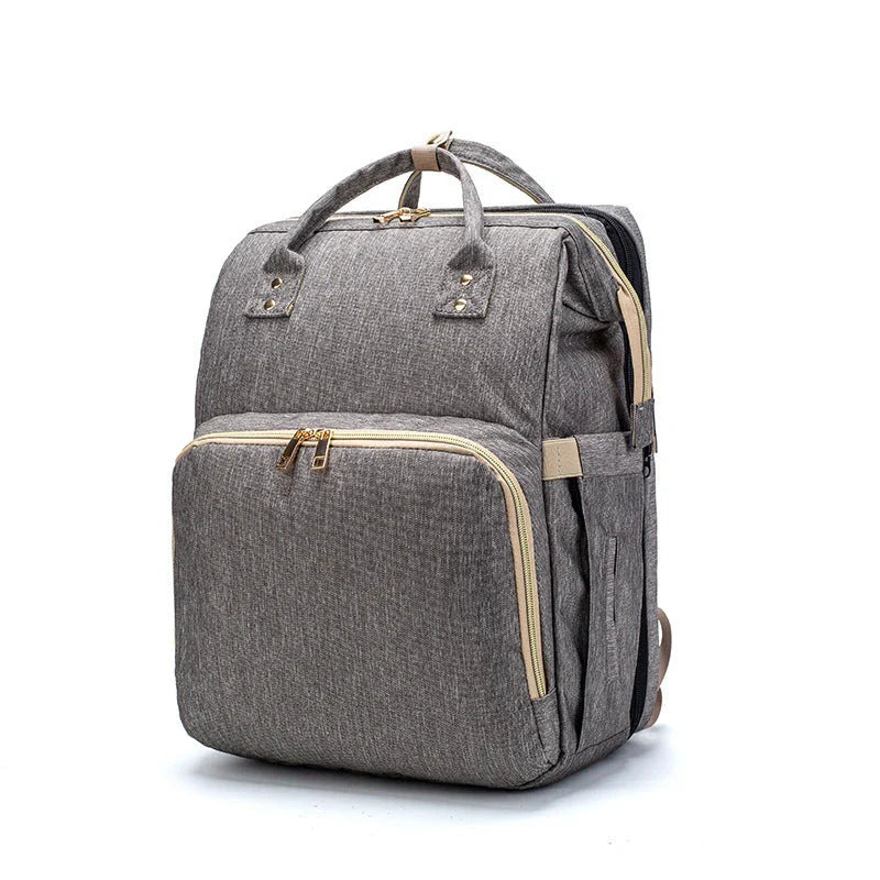 Versatile baby changing backpack with USB charging port and folding portable bed