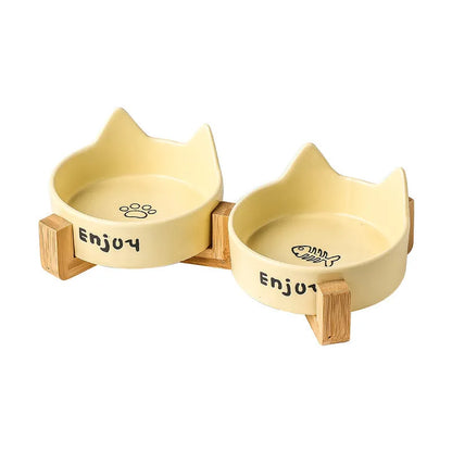Porcelain cat bowl with anti-tumble wooden frame in pink with a cat paw design