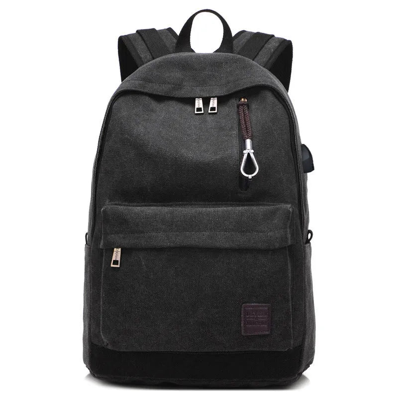 Coffee-coloured canvas backpack with USB charging port on side strap and front zipper pocket.