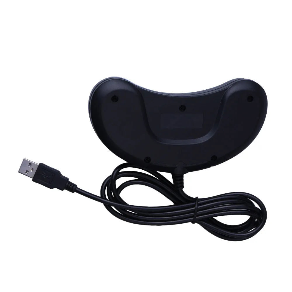 Black Sega-style USB game controller for PC with a long braided cable on a desk