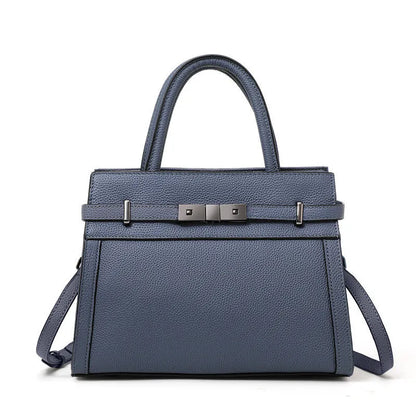 Women's square genuine leather crossbody handbag in clamshell style with internal compartments.