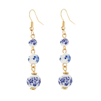 Long retro earrings with blue and white porcelain ceramic beads and geometric alloy construction