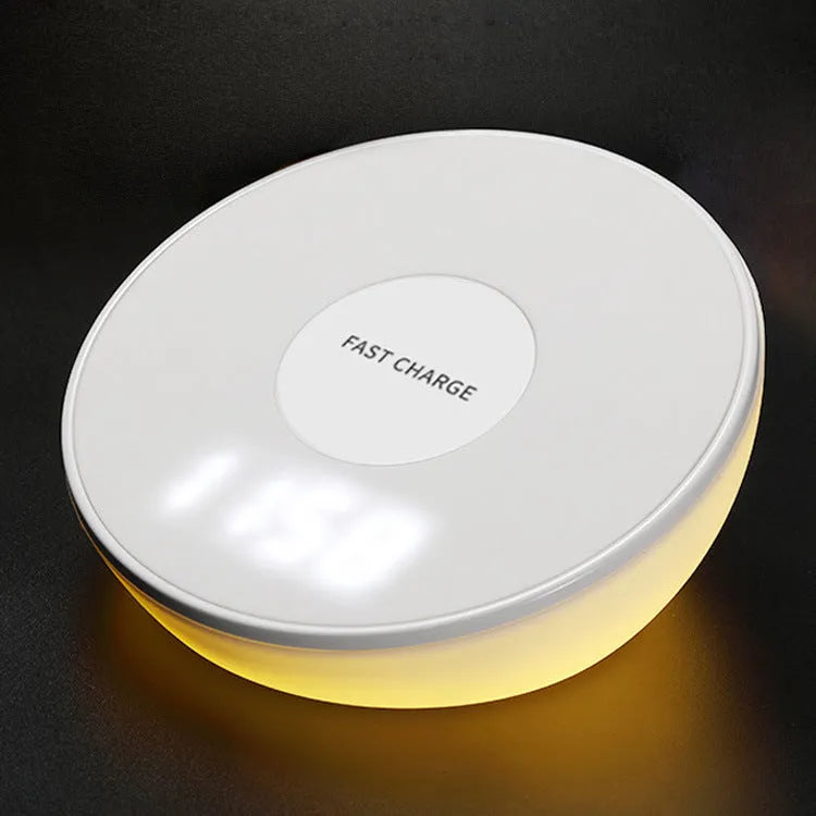 White 10W wireless charging pad with digital clock display and three control buttons on a bedside table
