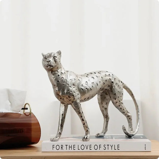 Leopard resin home ornament in American Leopard colour showing three pose variations on wooden surface