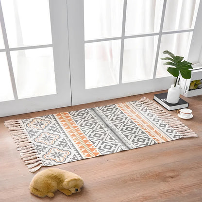 Hand-woven Scandinavian style linen cotton rug with woven tassels in plant-dyed colours measuring 60x90cm