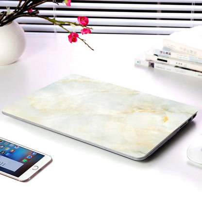 Plastic MacBook protective case in a marble pattern colour, shown next to a compatible Apple laptop.