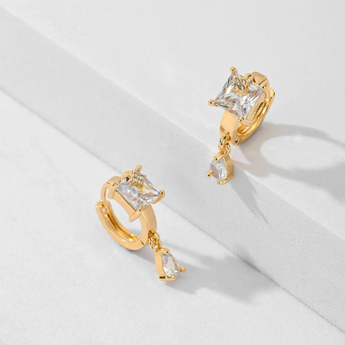 Trendy copper-plated gold fashion earrings with water droplet design in multiple colors.