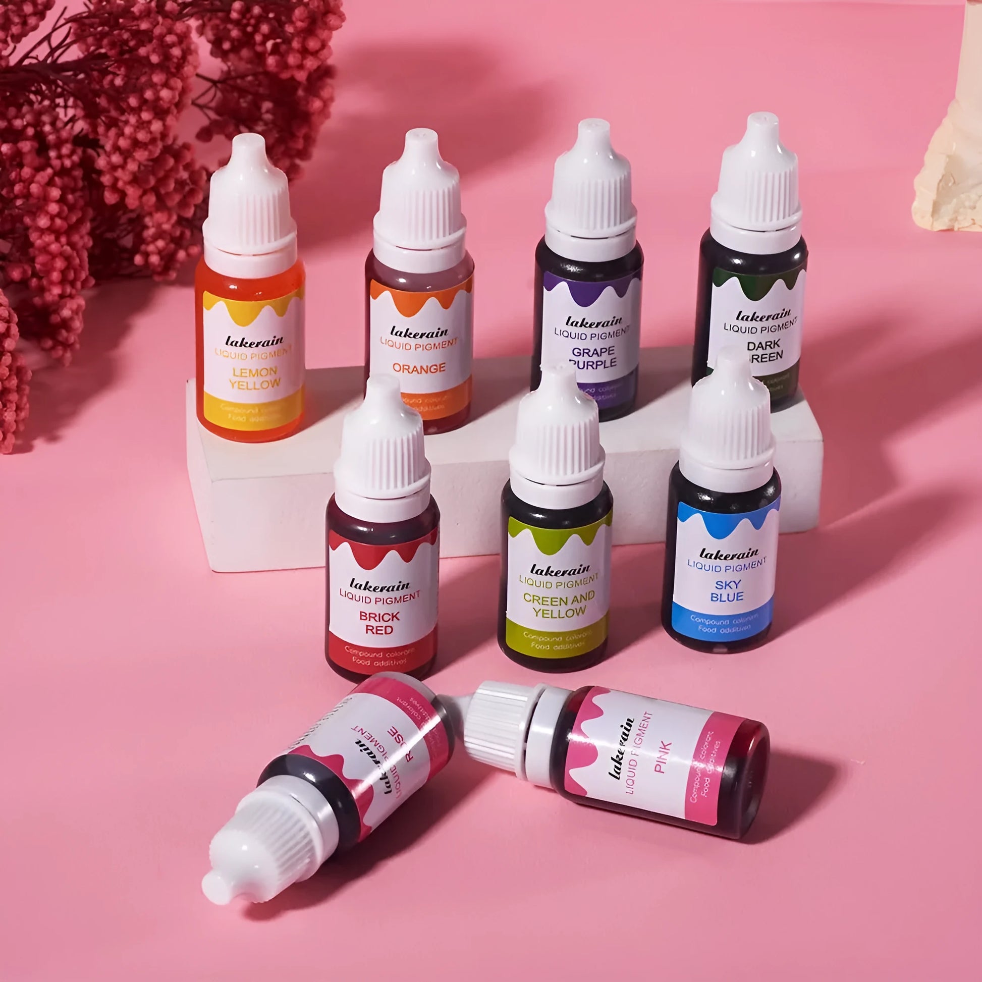 Set of 24 small bottled edible pigment colours in a toolbox with crafting accessories like glitter and sponges.