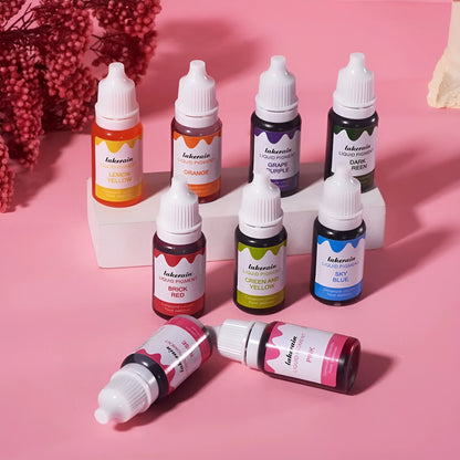Set of 24 small bottled edible pigment colours in a toolbox with crafting accessories like glitter and sponges.