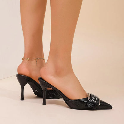 Black women's pointed toe high heel sandals with a decorative buckle on the front strap.