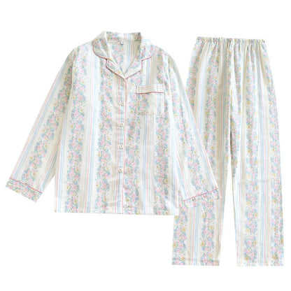 Red fruit print cotton gauze ladies' pyjama set with long sleeves and trousers laid flat.