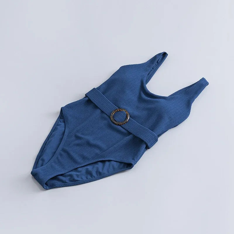 Navy blue women's one-piece swimsuit with triangle top and built-in chest pads for swimming