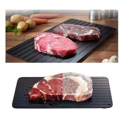 Black aluminium fast defrosting tray for thawing frozen food on kitchen counter