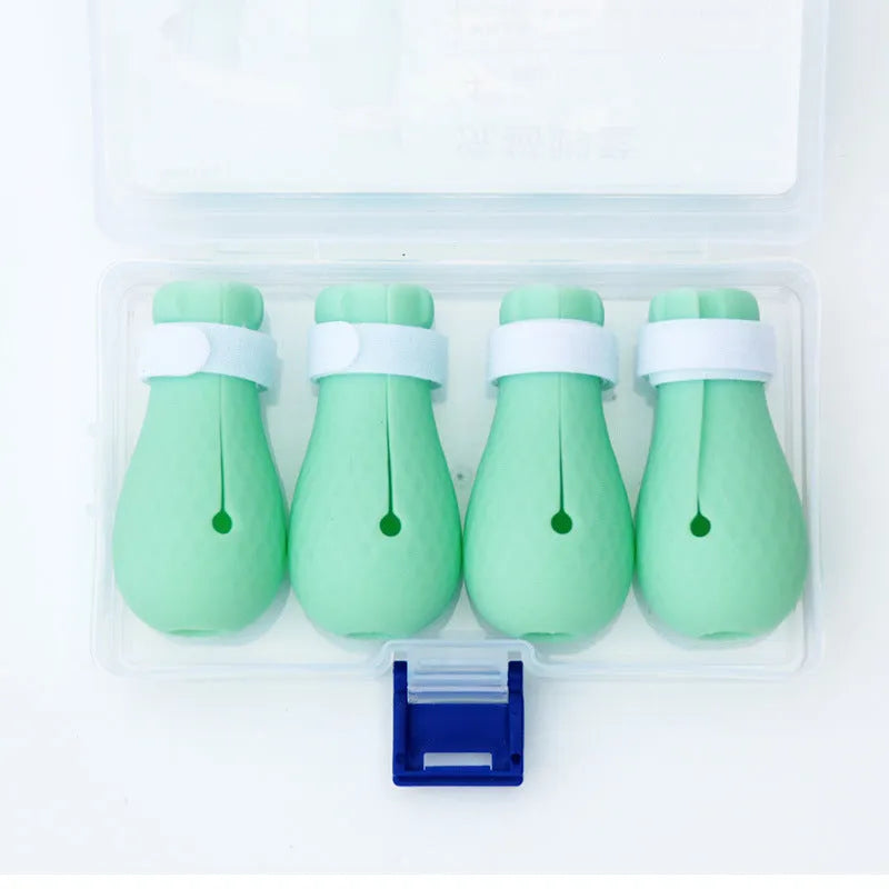 Four transparent green silicone cat paw covers for scratch protection during grooming and care