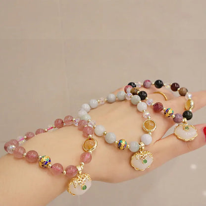 Geometric ethnic style jade bracelet for women with metal charm decoration in gray or strawberry quartz.