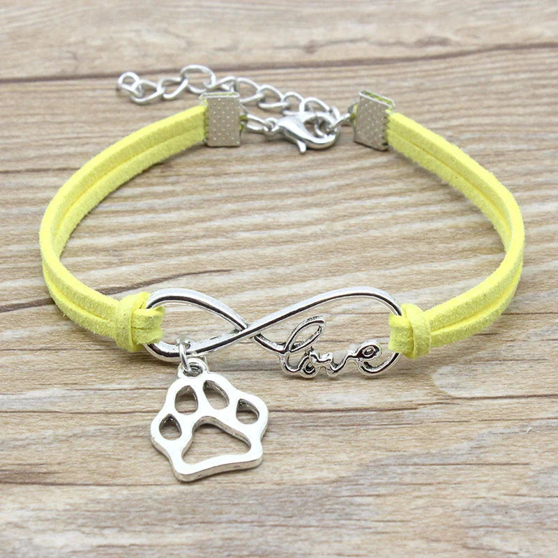 Hand-woven Infinite Love Pet Bracelet in various colors, showcasing the bow shape and alloy material.
