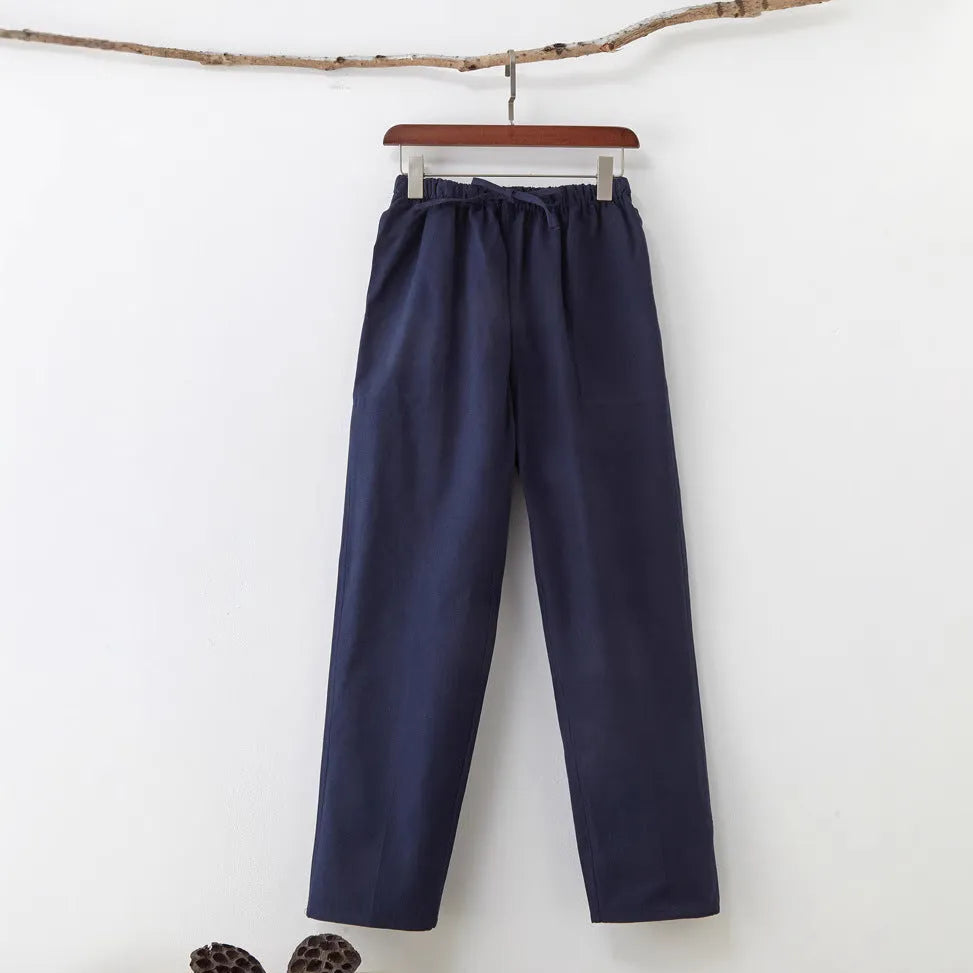 Men's beige pure cotton casual trousers with a drawstring waist on a mid-grey background.