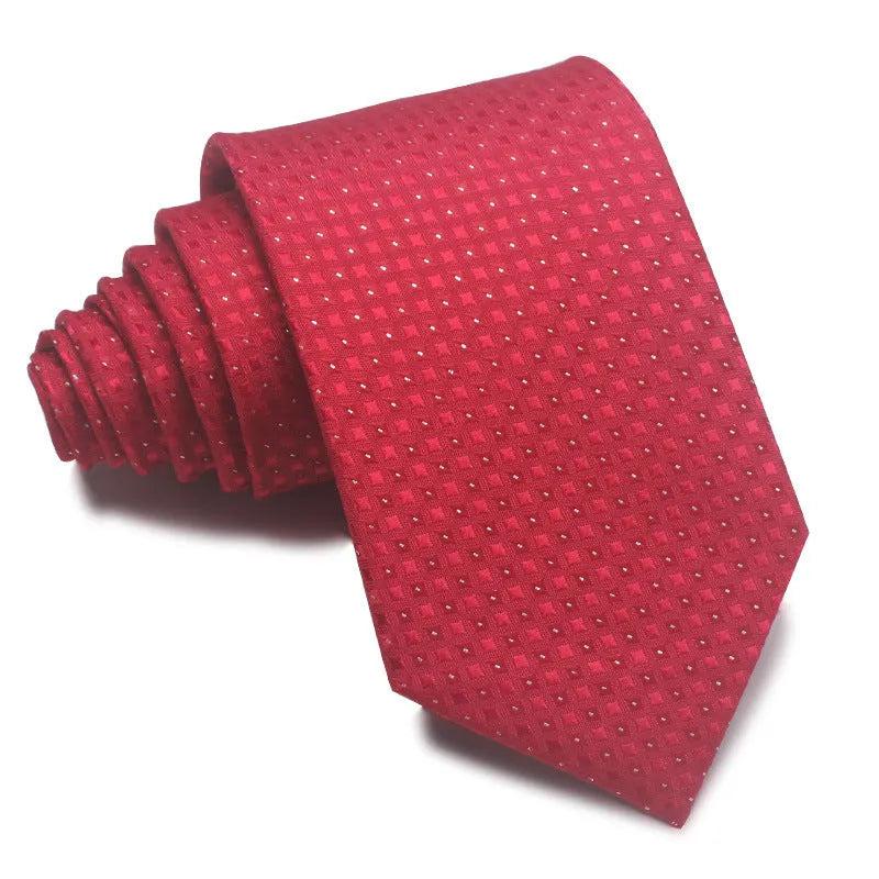 Close-up of a red and black striped jacquard weave tie with an arrow tip, showing texture.
