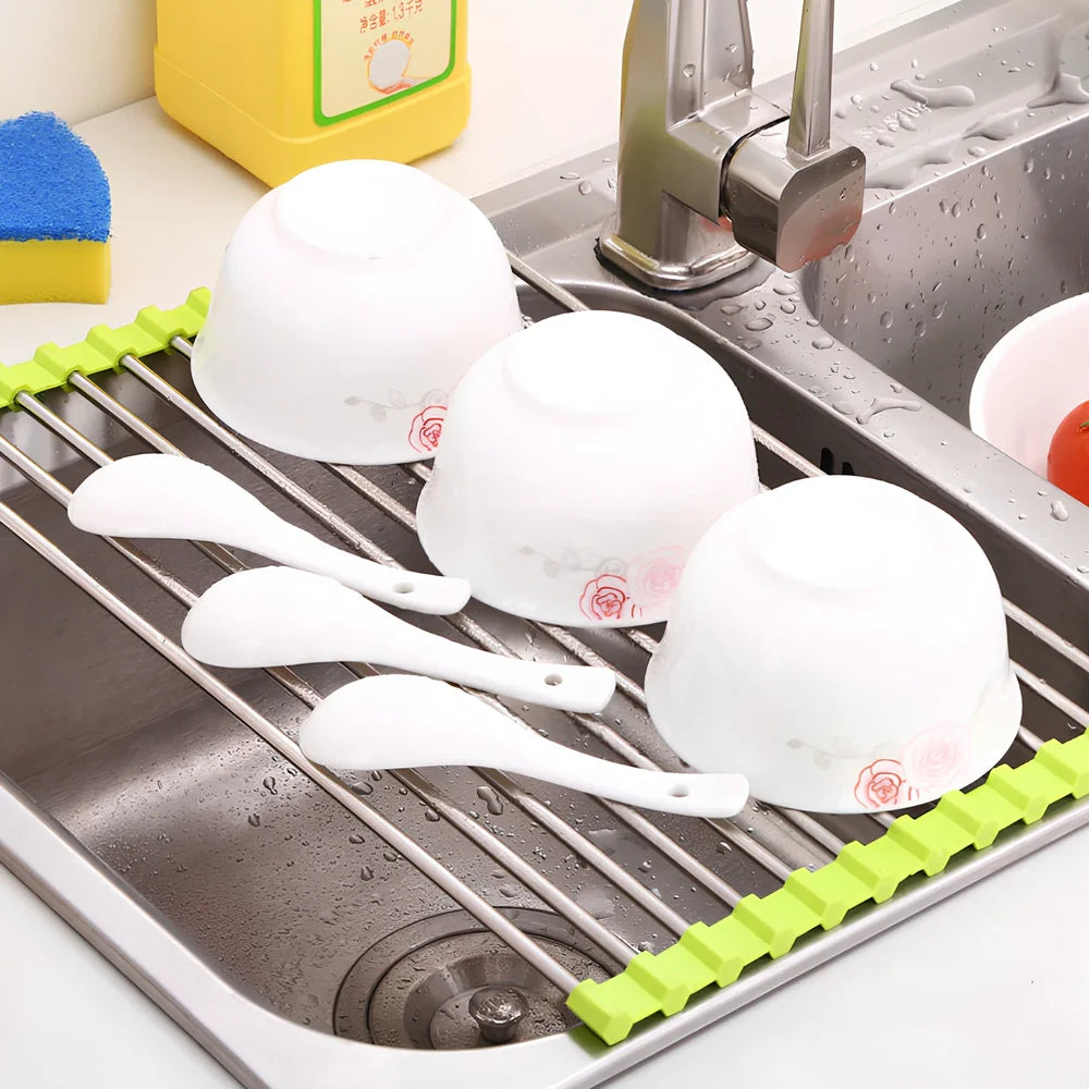 Black folding stainless steel sink drain rack with silicone edges, shown both unfolded for drying and folded for storage