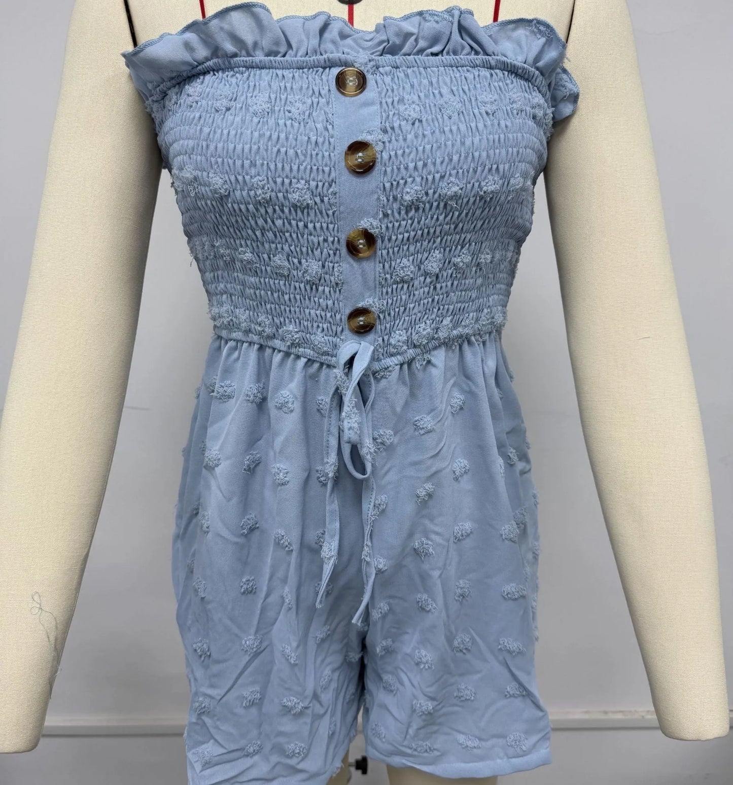 Women's off-shoulder sleeveless jumpsuit in polyester fabric with button detailing and mid-waist design