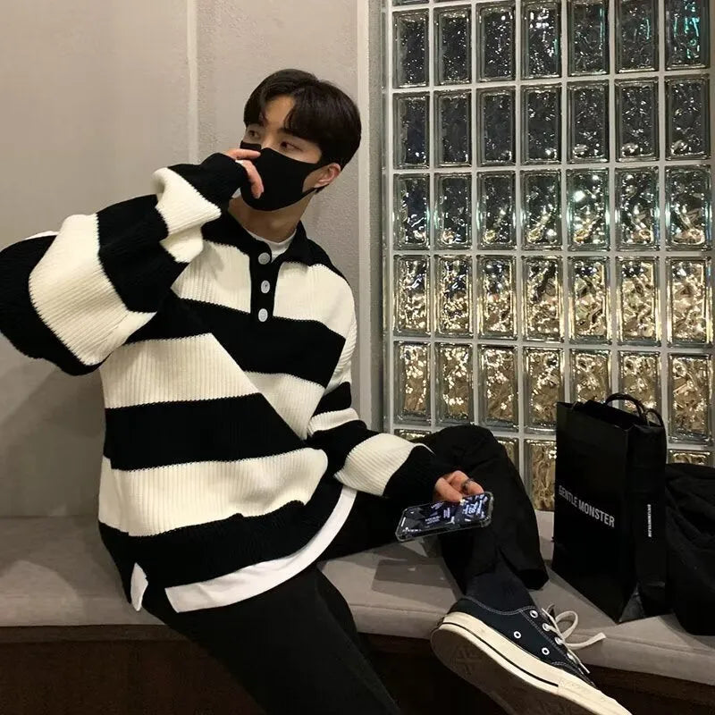 Man wearing a loose-fit black and grey striped polyester pullover sweater